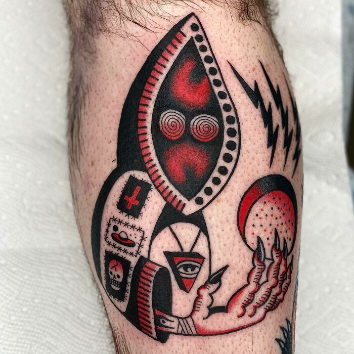 Colorful punk wizard tattoo on shin featuring trippy design elements in red and black.