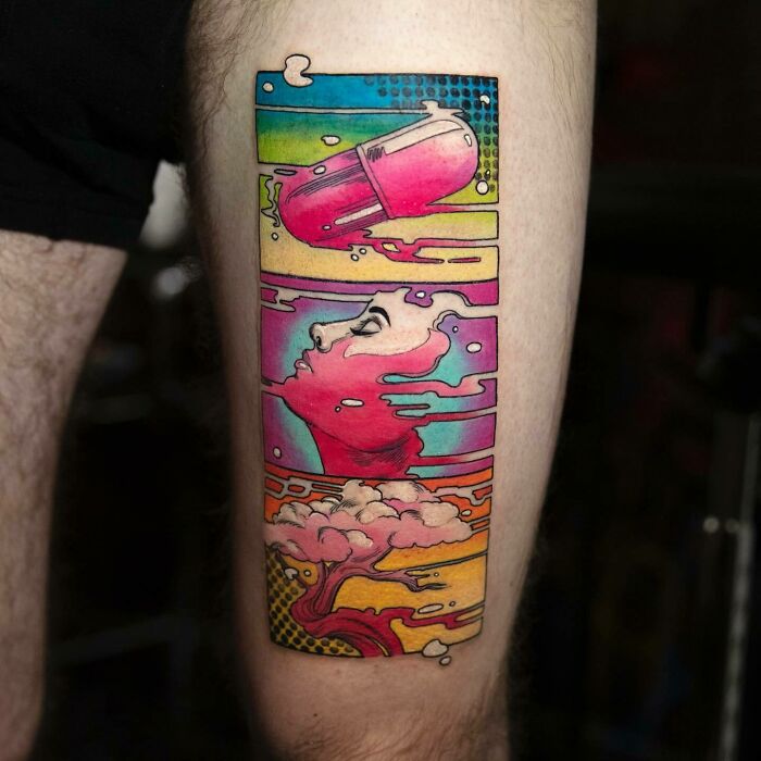 Colorful trippy tattoo with surreal imagery and vibrant design elements on a person's leg.
