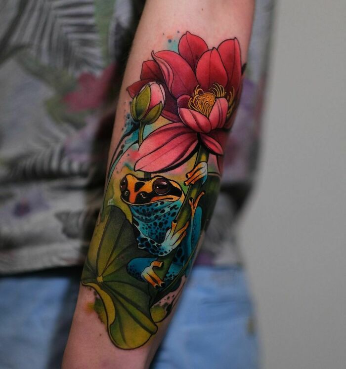 Colorful tattoo of a frog with a pink flower, showcasing psychedelic art on an arm.