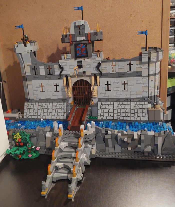 Detailed LEGO castle build with a moat and drawbridge showcasing incredible LEGO builds as real works of art.