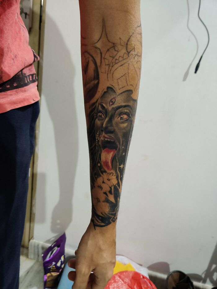 Kali half sleeve tattoo with intricate, trippy designs, showcasing vibrant colors on an arm.