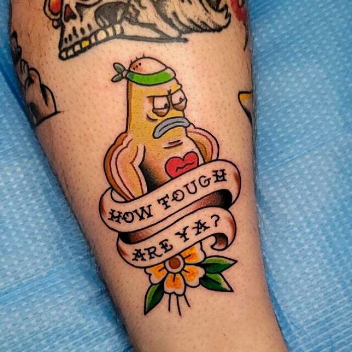 Colorful trippy tattoo of a tough character with a headband and a ribbon saying "HOW TOUGH ARE YA?" on a person's arm.