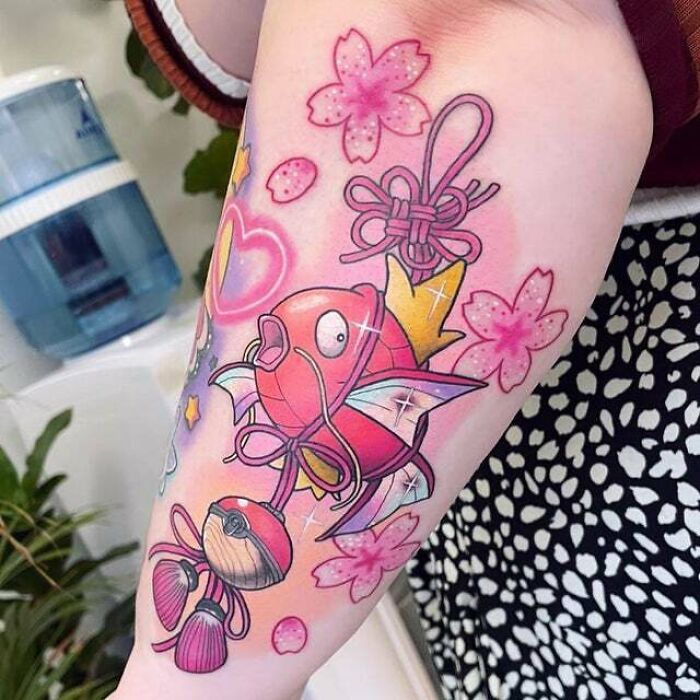 Colorful trippy tattoo of a fish and pink flowers, showcasing psychedelic art on an arm.