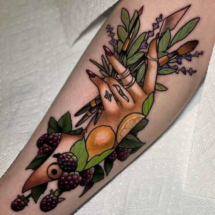 Psychedelic art tattoo featuring a hand with leaves, berries, and citrus, blending natural elements in vibrant colors.