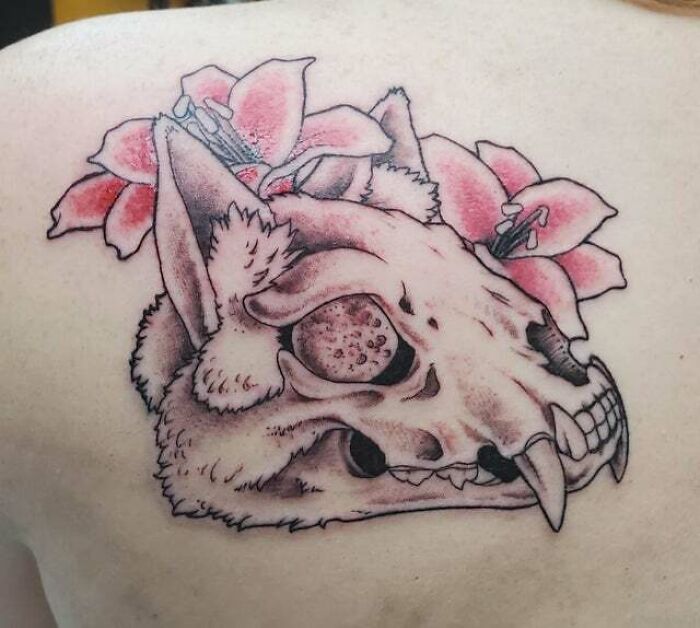 Trippy tattoo featuring a psychedelic skull with floral elements.