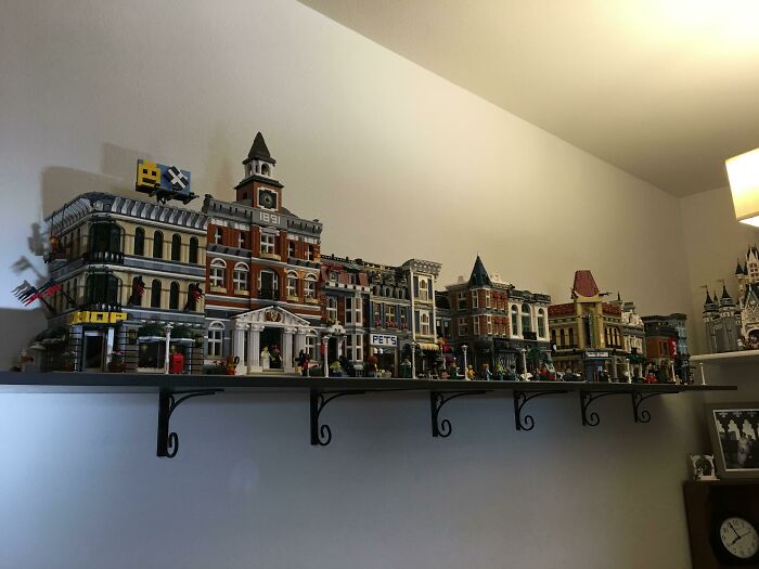 Detailed LEGO builds of city buildings on a wall shelf showcasing incredible LEGO creations as real works of art.