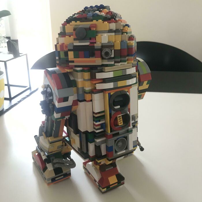Multicolored LEGO build of a robot resembling R2-D2, showcasing one of the incredible LEGO works of art.