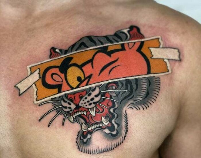 Trippy tattoo of a tiger and cartoon character merging on chest.
