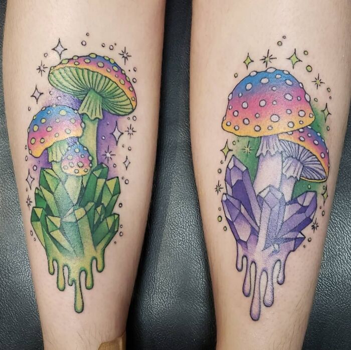Psychedelic art tattoos featuring colorful mushrooms and crystals on legs.