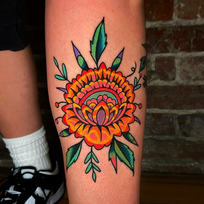 Colorful trippy tattoo of a vibrant flower on a leg, inspired by psychedelic art.