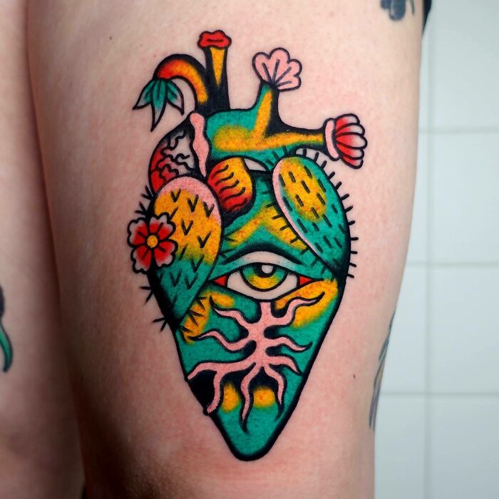 Trippy tattoo of a colorful heart with an eye and flowers.
