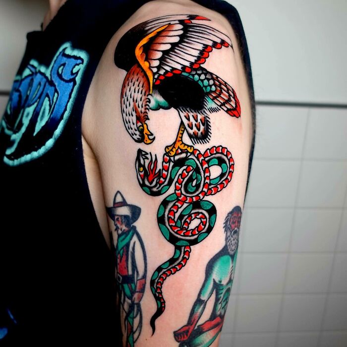Colorful psychedelic tattoo of an eagle and snake on an arm, showcasing vibrant trippy art design.
