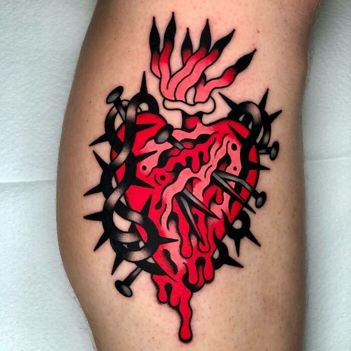 Trippy tattoo featuring a vibrant red heart with thorns and nails, creating a surreal optical illusion effect.