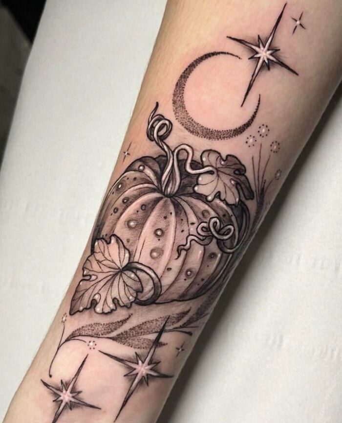 Psychedelic art tattoo featuring a stylized pumpkin, crescent moon, and stars on a forearm.