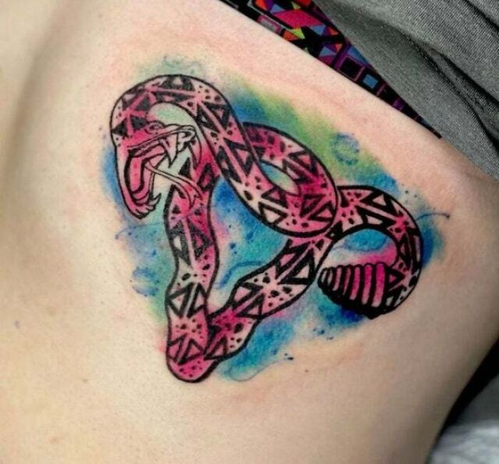 Colorful geometric snake tattoo with trippy patterns and vibrant background.