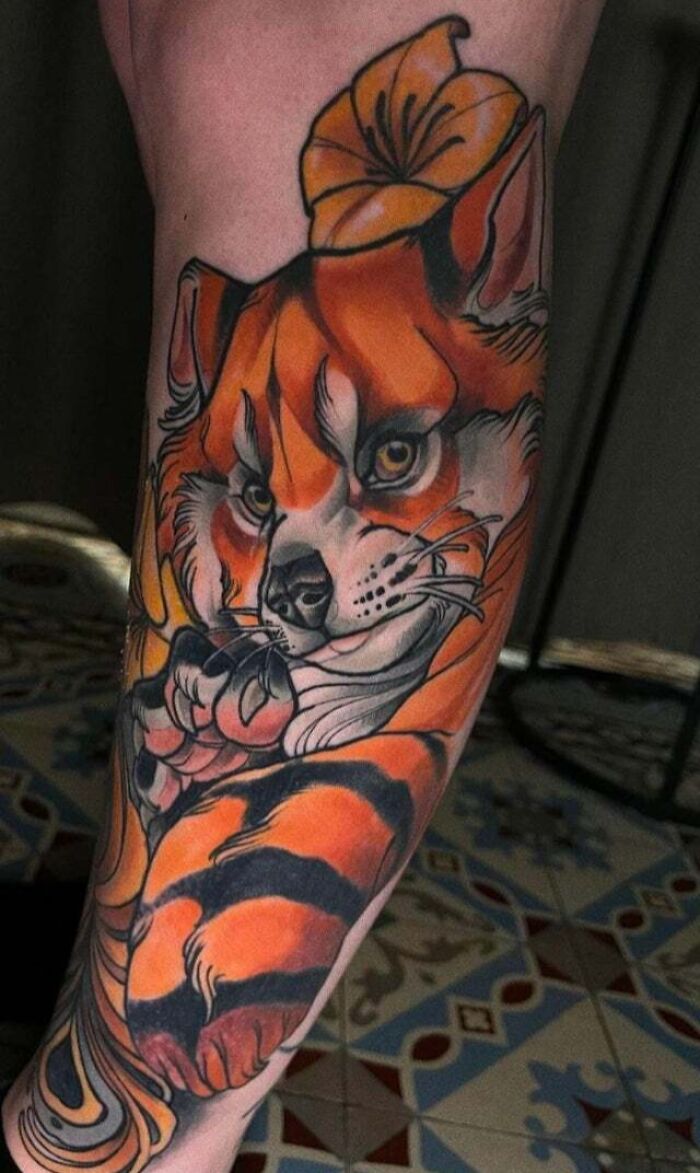 Psychedelic art tattoo of a colorful fox on an arm.