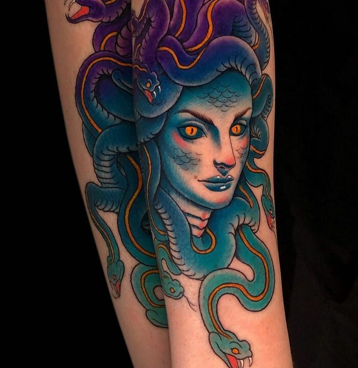 Colorful trippy tattoo of a Medusa face with vivid snakes, showcasing detailed artistry.