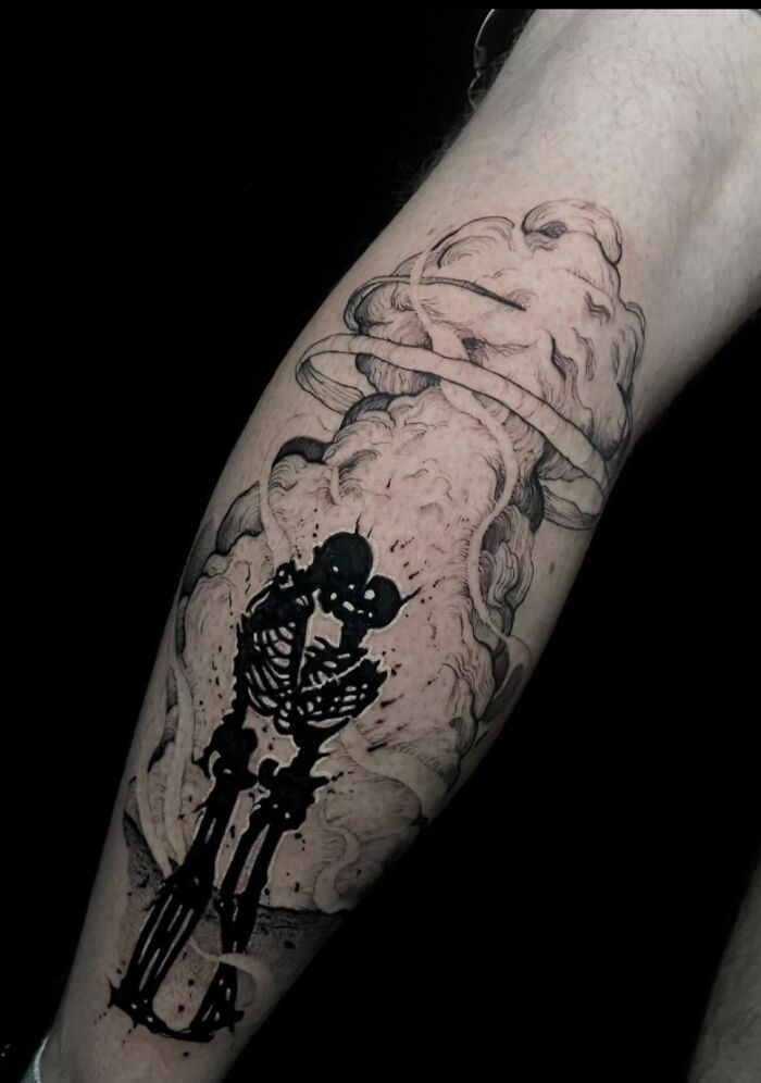 Trippy leg tattoo of a skeleton with a watchman explosion design, blending surreal and dramatic elements.