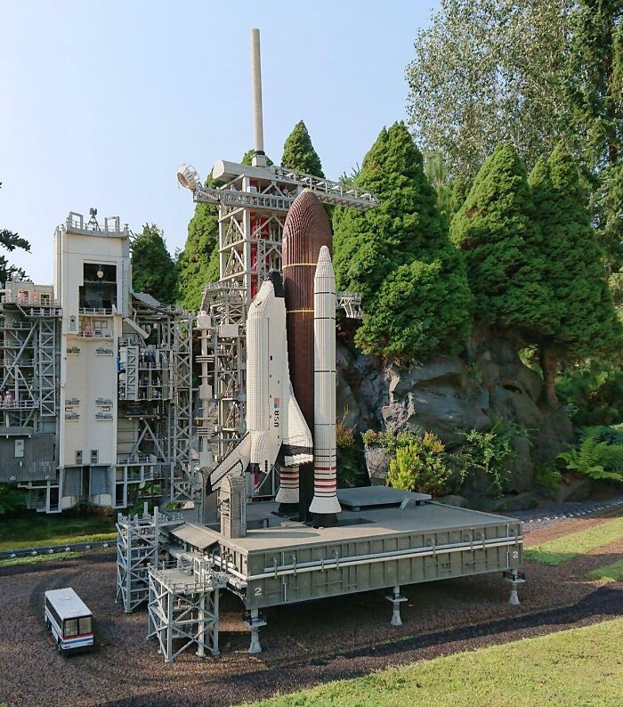 Detailed LEGO build of a space shuttle and launch pad surrounded by trees, showcasing incredible LEGO art craftsmanship.