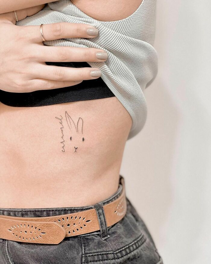 Minimalist pet tattoo of a bunny on skin, capturing the love for furry friends.