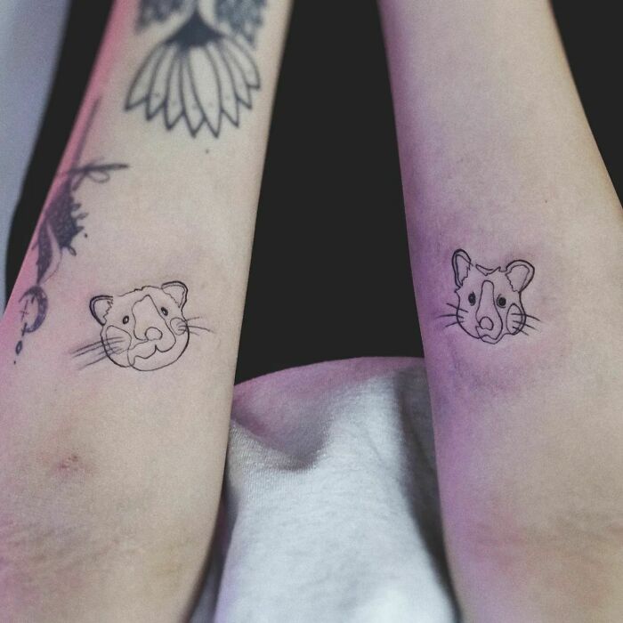 Minimalist pet tattoos featuring cute animal faces on forearms.