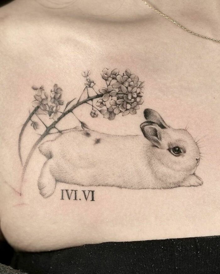 Tattoo of an adorable pet rabbit with flowers, showcasing meaningful art to immortalize a cherished companion.