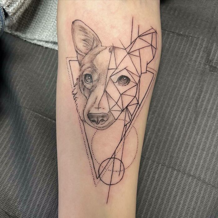 Geometric and realistic pet tattoo of a dog on forearm celebrating furry friends.