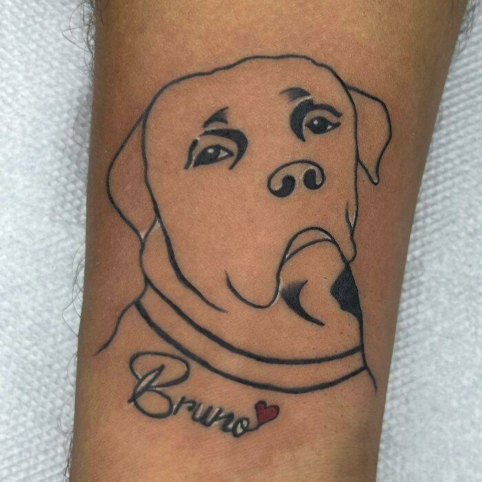 Pet tattoo of a dog's face with "Bruno" written below, celebrating furry friends.