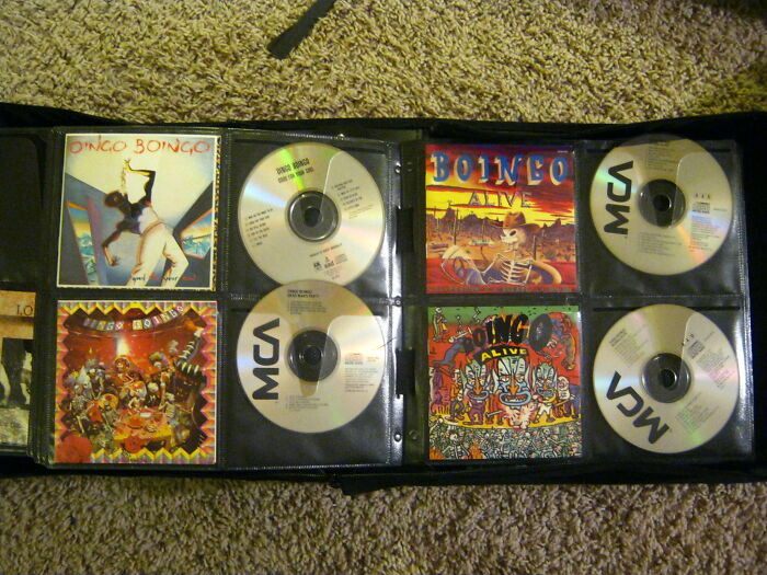 CD collection featuring Bongo Bongo albums spread out on carpet, evoking nostalgic Gen X memories from music era.