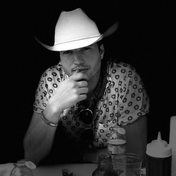 Portrait of a male celebrity wearing a cowboy hat and patterned shirt, representing smartest celebrities known for intelligence.