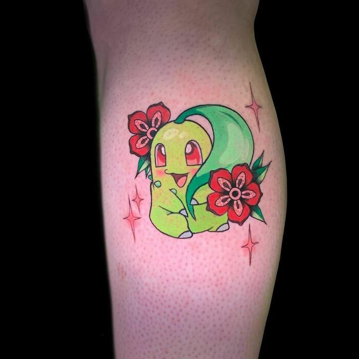 Cartoon tattoo featuring a cute green character with flowers, inspired by animated shows.