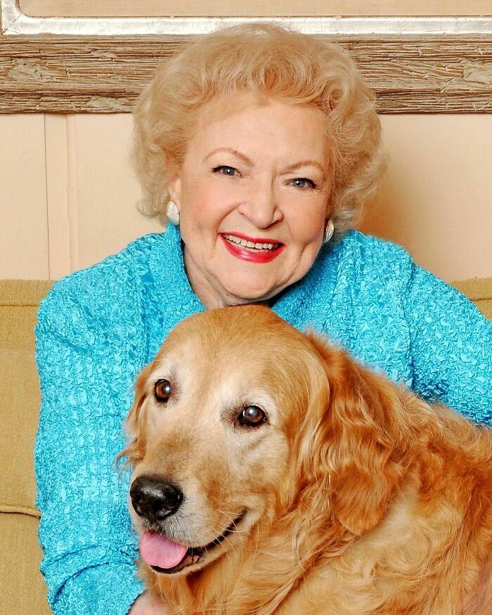 Elderly woman smiling while sitting with a golden retriever, showcasing smartest celebrities known for intelligence and talent.