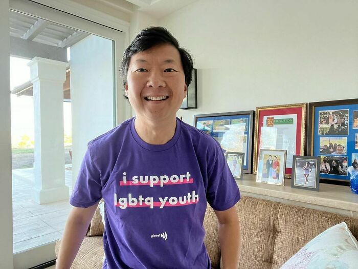 Man wearing a purple shirt supporting lgbtq youth, representing smartest celebrities known for being talented and intelligent