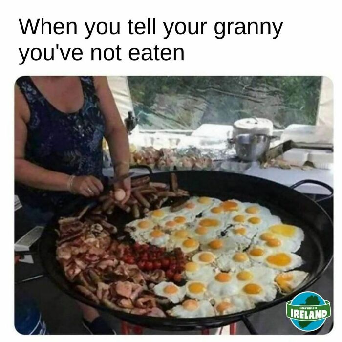 Woman cooking a large traditional Irish breakfast with eggs, sausages, and bacon, showing why Ireland is a world apart.