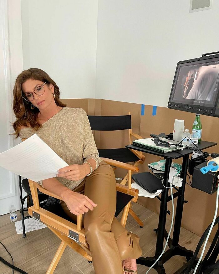 Woman celebrity reading a script on set, showcasing the smartest celebrities who are talented and intelligent.