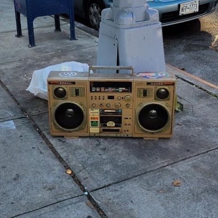 Vintage boombox found thrown away on sidewalk, illustrating one man’s trash is another man’s treasure.