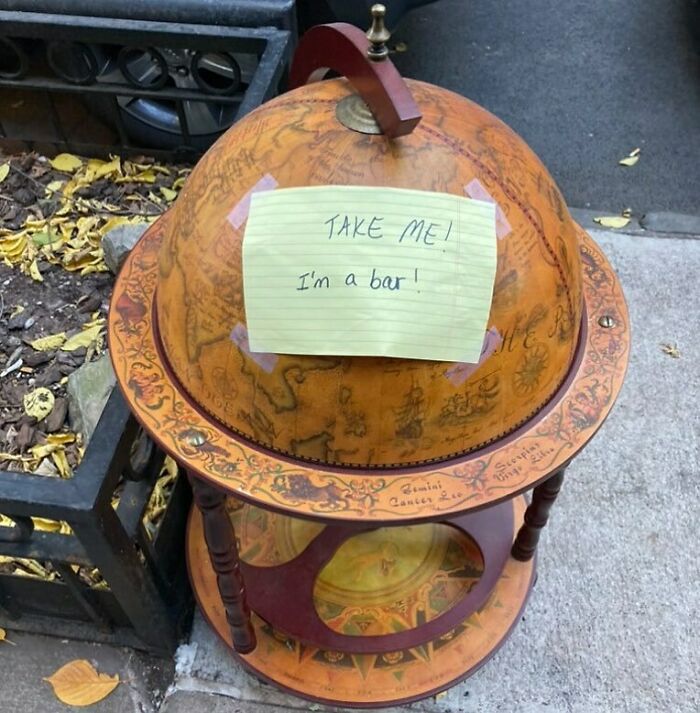 Vintage globe bar with a handwritten sign saying take me, found thrown away as one man's treasure on the street.