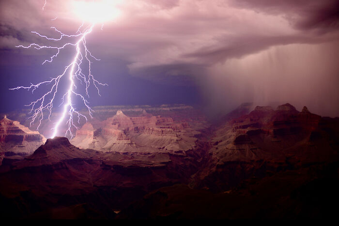 Lightning striking over the Grand Canyon during a storm, captured in a dramatic nature photographer of the year winning image.