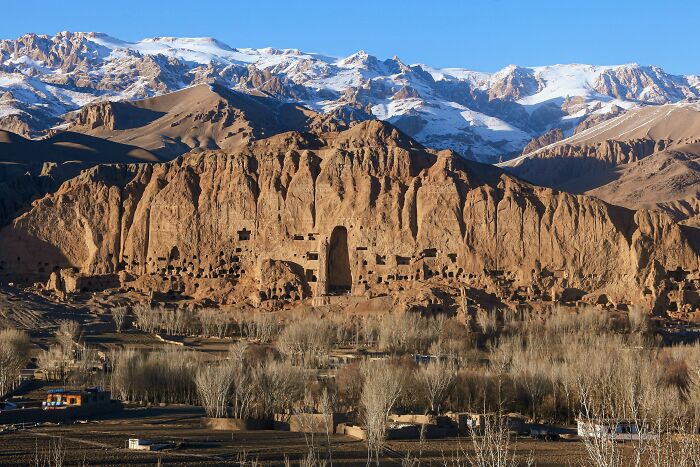 Ancient Buddhist caves and cliffs in Afghanistan’s mountainous landscape, showcasing unique historical and cultural heritage.