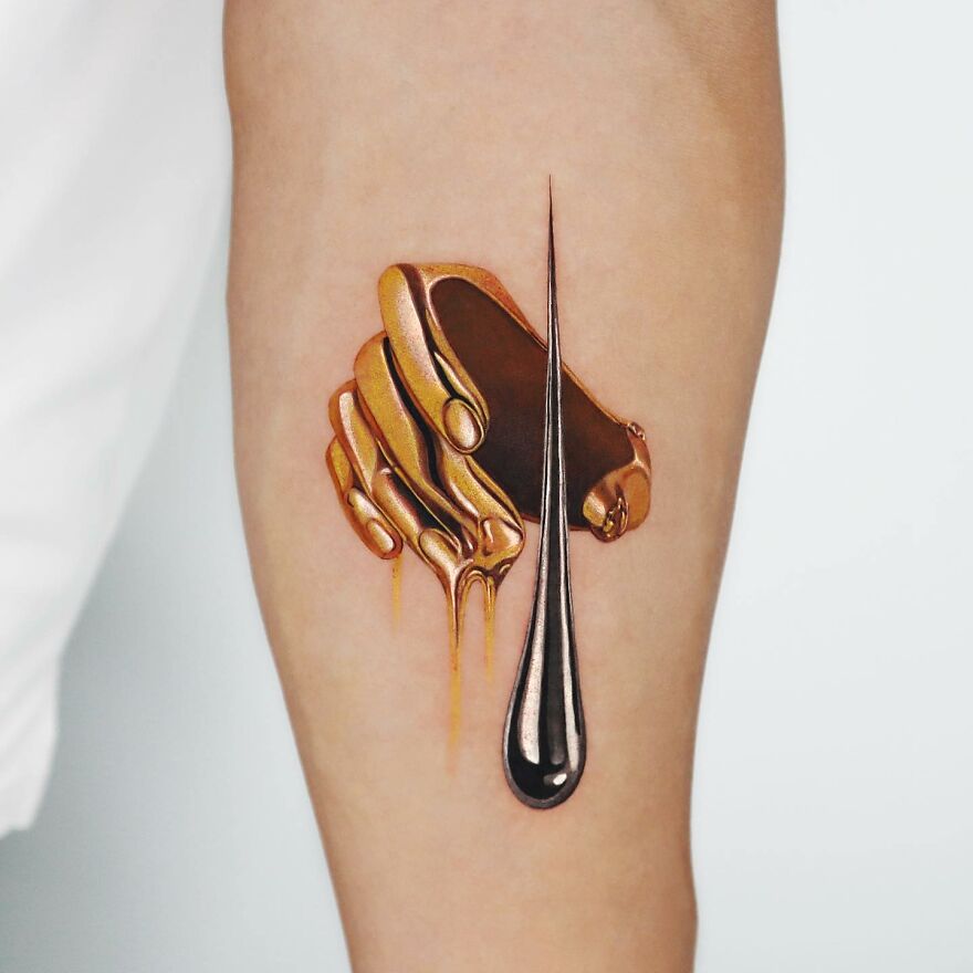 Golden tattoo of hands with drips, crafted by a Manhattan-based artist.