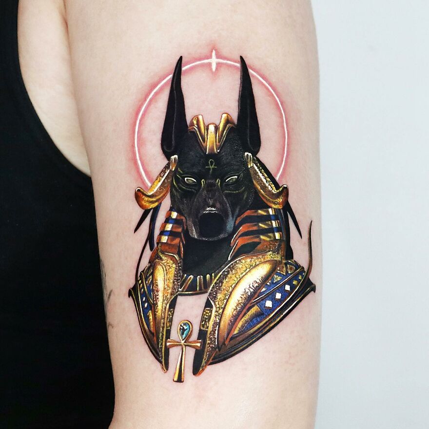 Golden Anubis tattoo with intricate details by Manhattan tattoo artist.