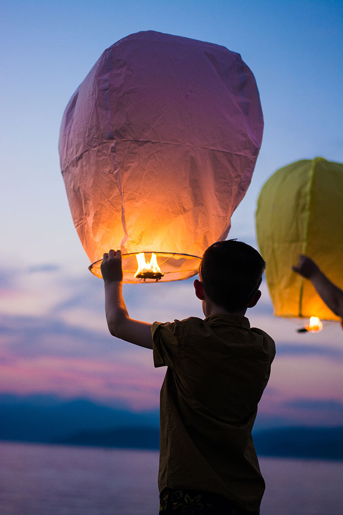 Person holding lighted lantern