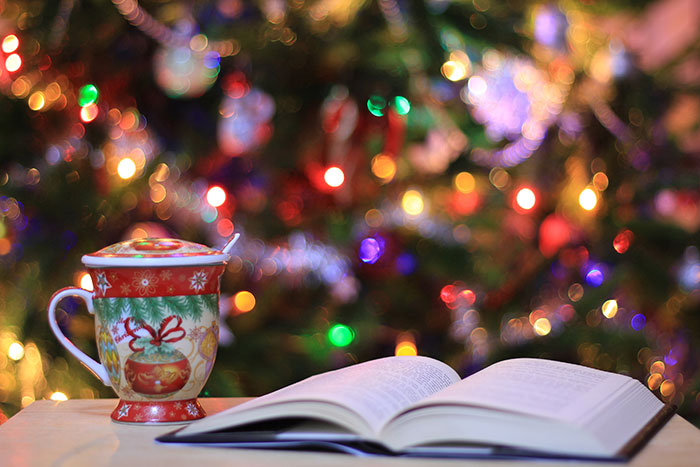 Book and Christmas cup on the table