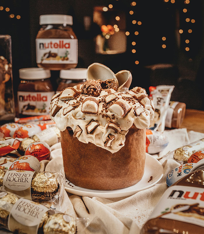 Panettone with candies, Nutella, chocolate eggs near