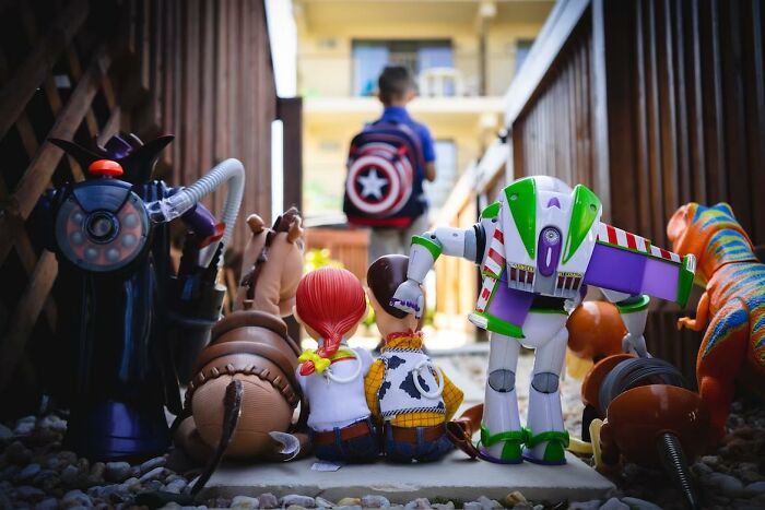 Toy characters like Buzz Lightyear and Woody observing a child walking away, illustrating criminally overpriced toys discussion.