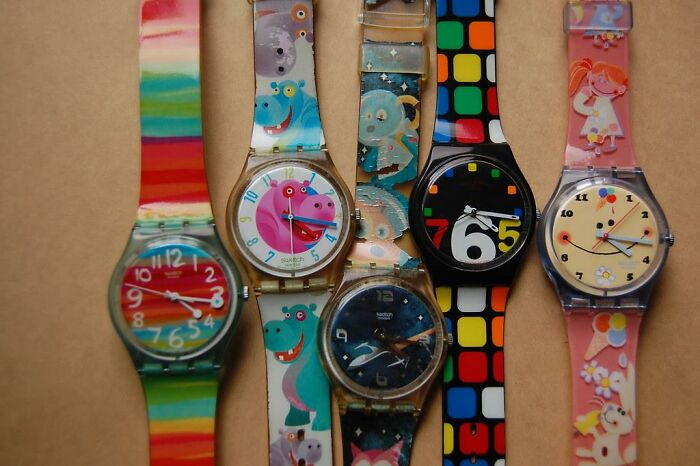 Colorful vintage Swatch watches with playful designs showcasing nostalgic Gen X fashion accessories collection.