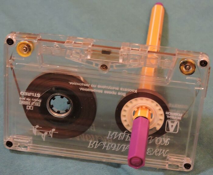 Clear cassette tape with a pencil inserted for rewinding, symbolizing iconic Gen X memories and nostalgia.