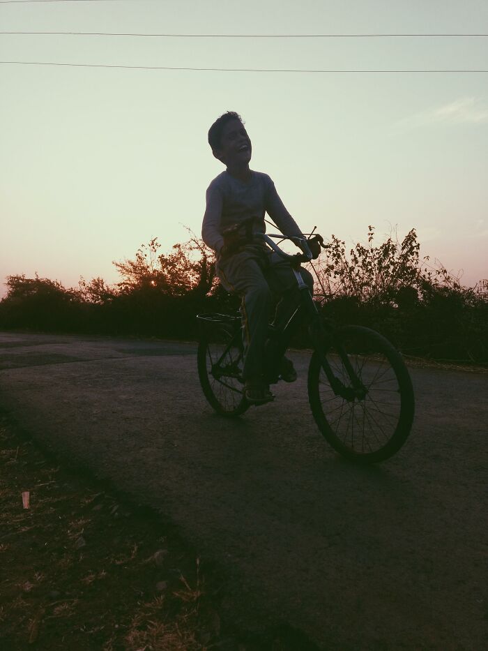 Child riding a bike at sunset, evoking nostalgic memories tied to the most Gen X experiences and childhood moments.