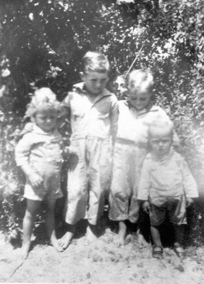 My Wife Grew Up Staring At This Picture. No One Can Remember If There Was A Person Behind The Kids, Or A Trick Of The Light