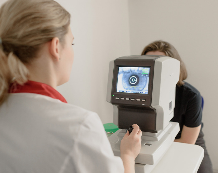 Doctor conducting an eye exam using diagnostic equipment, illustrating second opinion stories in medical care.